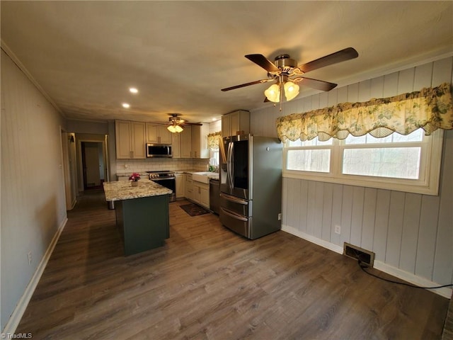 kitchen featuring backsplash, a center island, dark wood-type flooring, baseboards, and appliances with stainless steel finishes