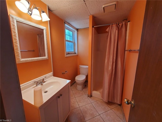 bathroom with tile patterned flooring, curtained shower, toilet, and vanity