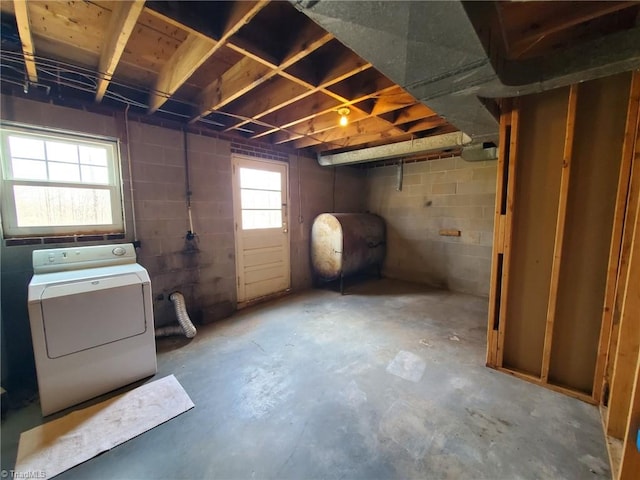 below grade area with concrete block wall, heating fuel, and washer / clothes dryer