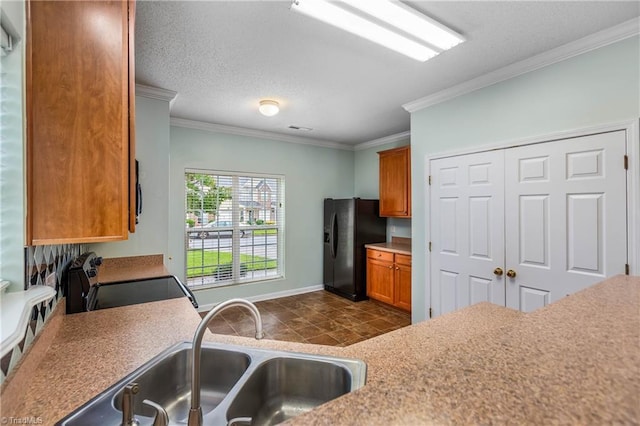 4339 Alderny Pl, High Point, NC 27265 - kitchen with black refrigerator with ice dispenser, electric stove, a sink, ornamental molding, and brown cabinetry