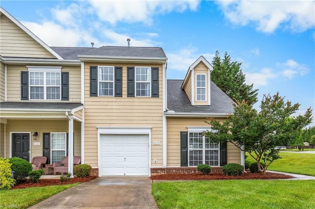 4339 Alderny Pl, High Point, NC 27265 - view of front of property featuring a front lawn, driveway, a porch, a garage, and brick siding