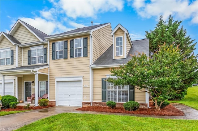 4339 Alderny Pl, High Point, NC 27265 - view of front of home with driveway, brick siding, a front yard, an attached garage, and a porch