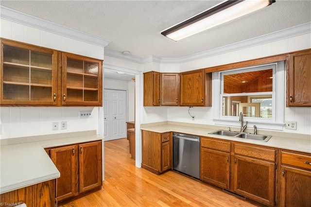 kitchen with crown molding, dishwasher, light wood-style floors, brown cabinetry, and a sink