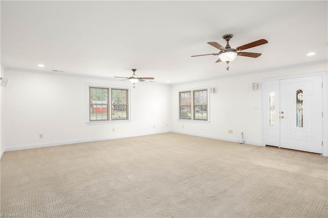 unfurnished living room with light colored carpet, a healthy amount of sunlight, and ceiling fan