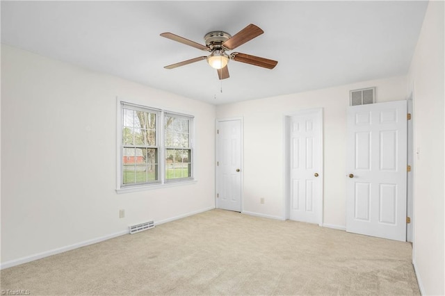 unfurnished bedroom with visible vents, carpet floors, and baseboards