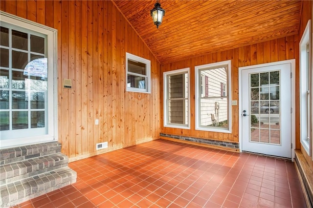 unfurnished sunroom with vaulted ceiling, visible vents, and wooden ceiling