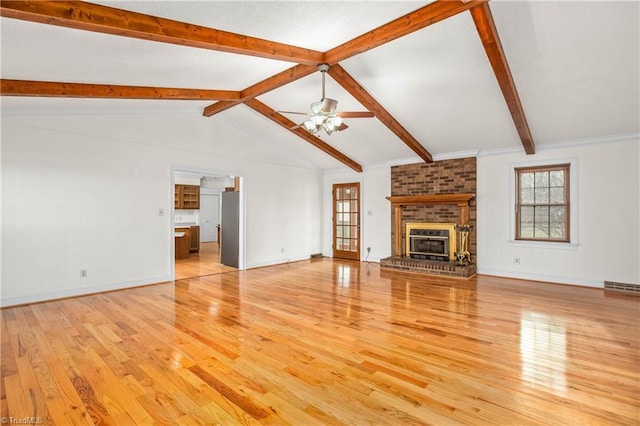 unfurnished living room featuring visible vents, a brick fireplace, ceiling fan, and light wood-style flooring