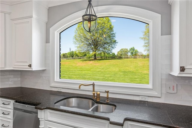 kitchen featuring sink, a healthy amount of sunlight, white cabinetry, and stainless steel dishwasher