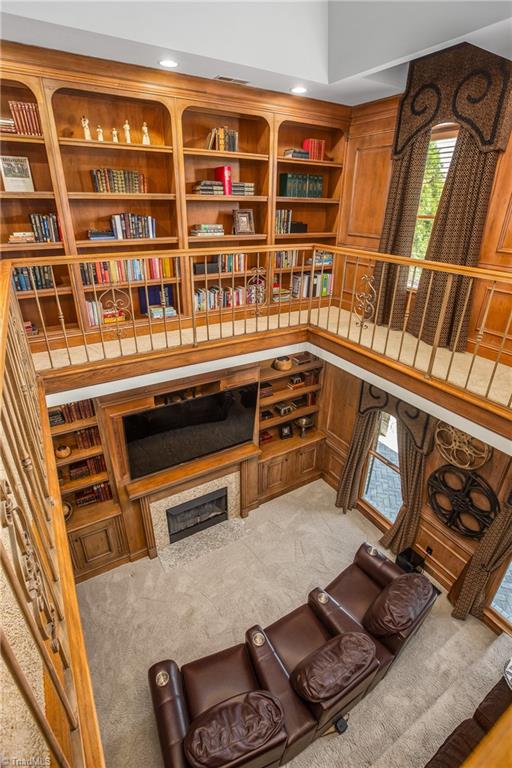 carpeted living room featuring built in features