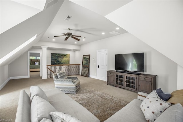 living room featuring light colored carpet, lofted ceiling, ceiling fan, and ornate columns