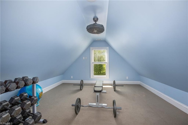 exercise area featuring vaulted ceiling and carpet floors