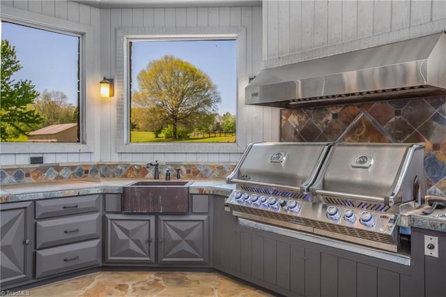 interior space with sink, an outdoor kitchen, and grilling area