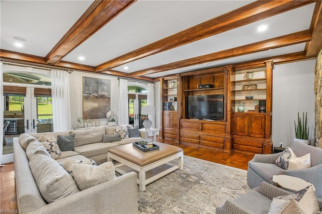 living room with french doors, built in features, hardwood / wood-style flooring, and beam ceiling