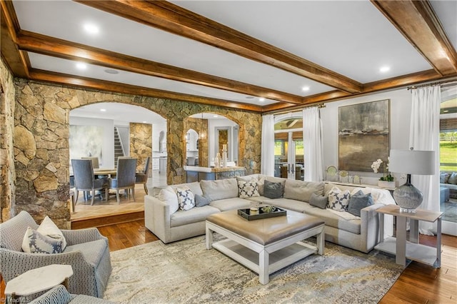 living room featuring french doors, wood-type flooring, and beamed ceiling