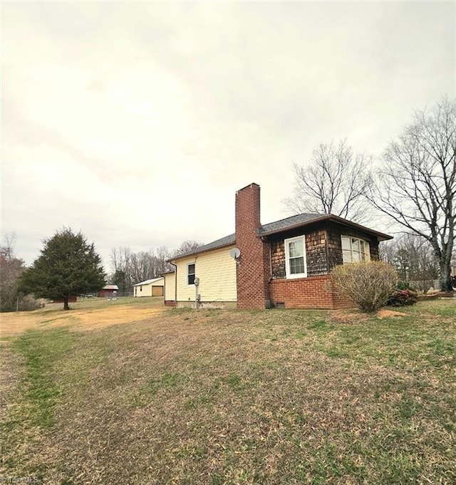 view of home's exterior with a yard