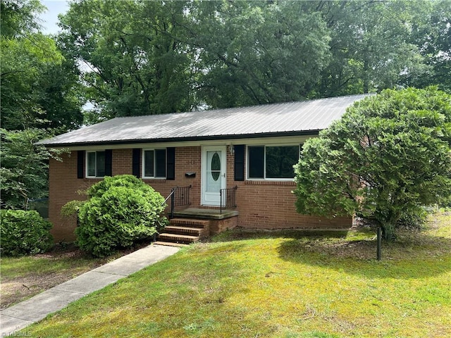 240 Byerly St, Mount Airy, NC 27030 - ranch-style home featuring brick siding, a front lawn, and metal roof