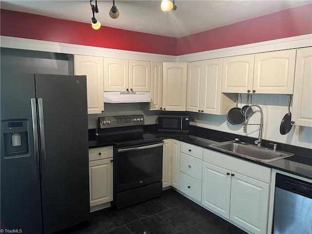 240 Byerly St, Mount Airy, NC 27030 - kitchen featuring stainless steel appliances, under cabinet range hood, a sink, dark countertops, and dark tile patterned floors