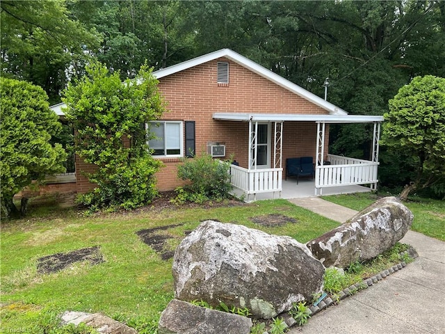 240 Byerly St, Mount Airy, NC 27030 - view of front facade with covered porch, brick siding, and a front lawn