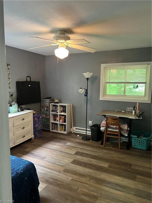 240 Byerly St, Mount Airy, NC 27030 - bedroom featuring dark wood finished floors, a ceiling fan, baseboards, and a baseboard radiator