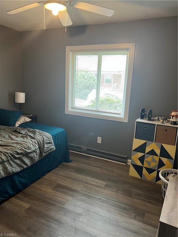 240 Byerly St, Mount Airy, NC 27030 - bedroom with dark wood-style flooring, ceiling fan, and baseboard heating