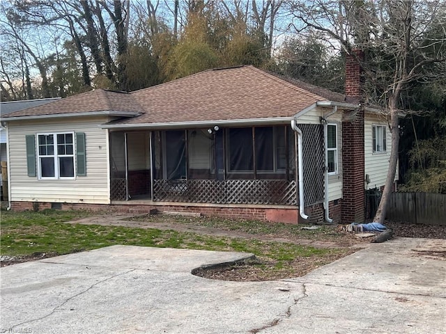 view of front of home featuring crawl space, a chimney, and roof with shingles