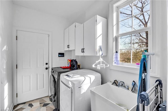 washroom with cabinets and washing machine and dryer