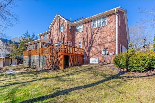 rear view of house featuring a yard and a deck