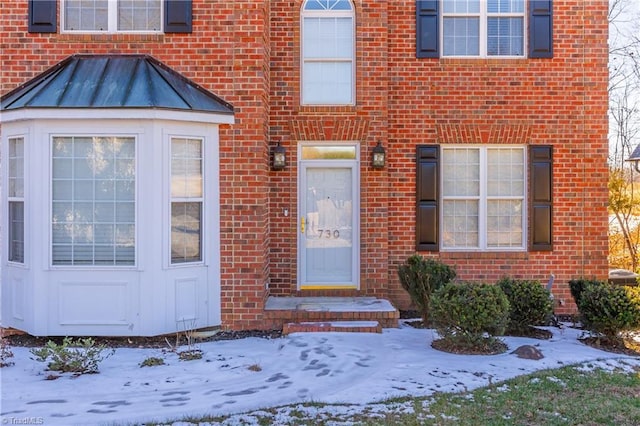 view of snow covered property entrance