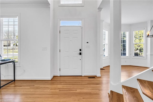 foyer entrance featuring plenty of natural light and light hardwood / wood-style floors