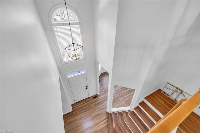 entryway featuring wood-type flooring and a chandelier