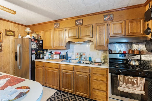 kitchen with ornamental molding, sink, and stainless steel appliances