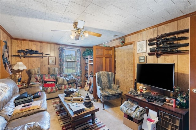 living room with ornamental molding, wooden walls, and ceiling fan