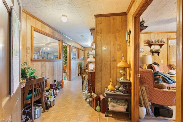 corridor featuring ornamental molding and wooden walls