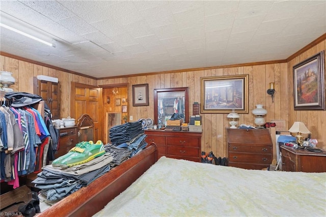 bedroom featuring crown molding and wood walls