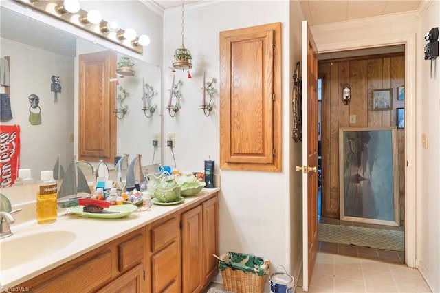 bathroom with vanity, ornamental molding, and tile patterned floors