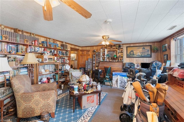 living room with wooden walls and ceiling fan