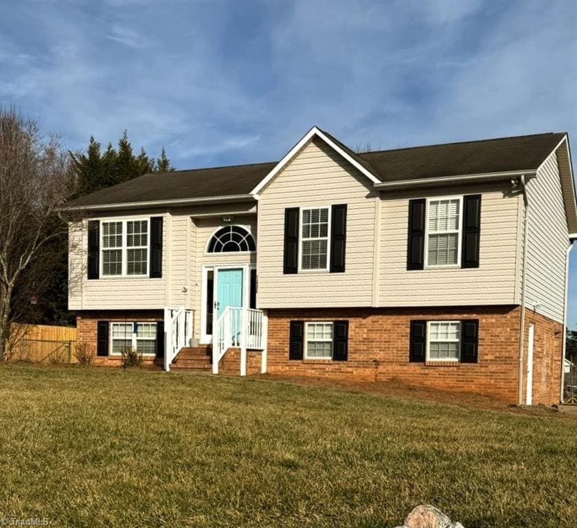 split foyer home with a front lawn