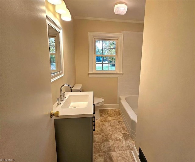 bathroom featuring a tub to relax in, vanity, crown molding, and toilet