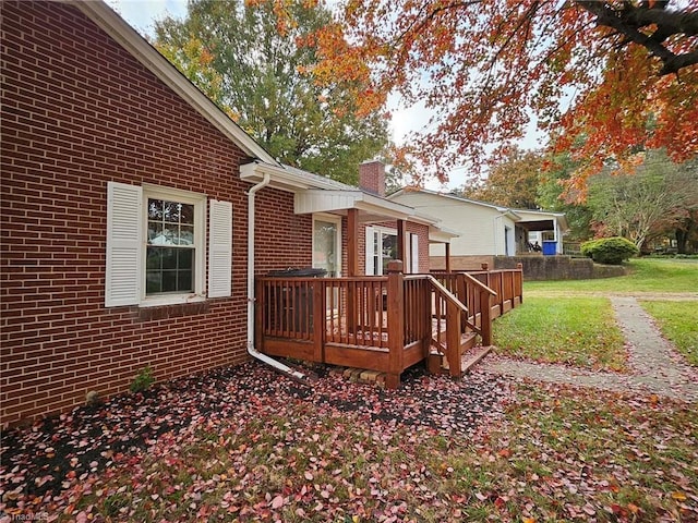 wooden deck with a lawn