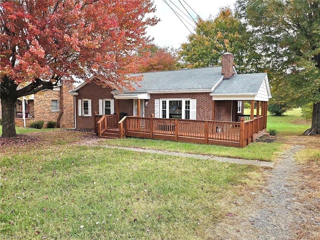 rear view of property with a deck and a lawn