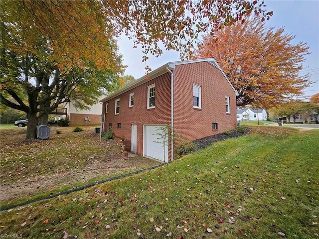 view of property exterior with a garage and a lawn