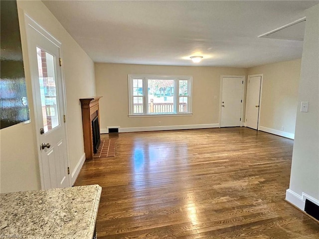 unfurnished living room featuring dark wood-type flooring