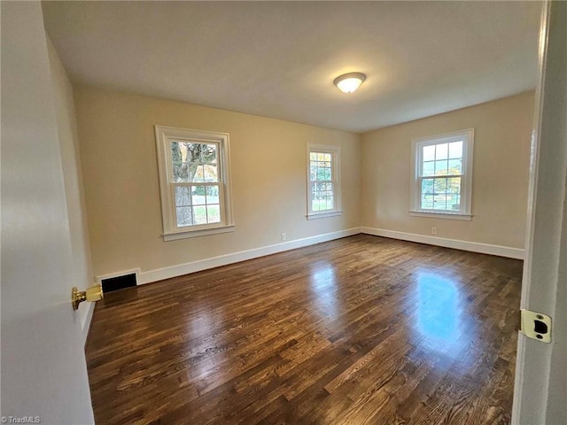 spare room featuring dark wood-type flooring