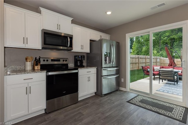 4628 Heatherly Rd, Winston-Salem, NC 27105 - kitchen with appliances with stainless steel finishes, dark wood-type flooring, light stone counters, white cabinets, and recessed lighting