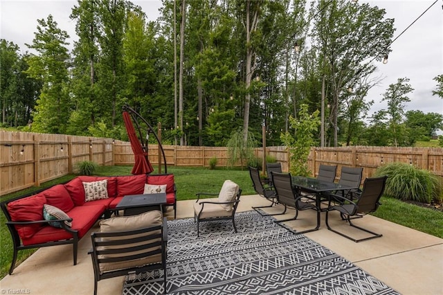 4628 Heatherly Rd, Winston-Salem, NC 27105 - fenced backyard with an outdoor hangout area, a patio area, outdoor dining area, and view of wooded area