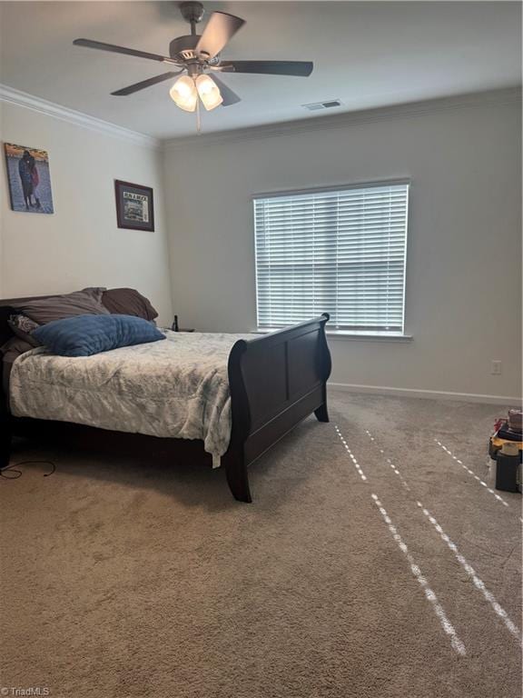 carpeted bedroom with ceiling fan and ornamental molding