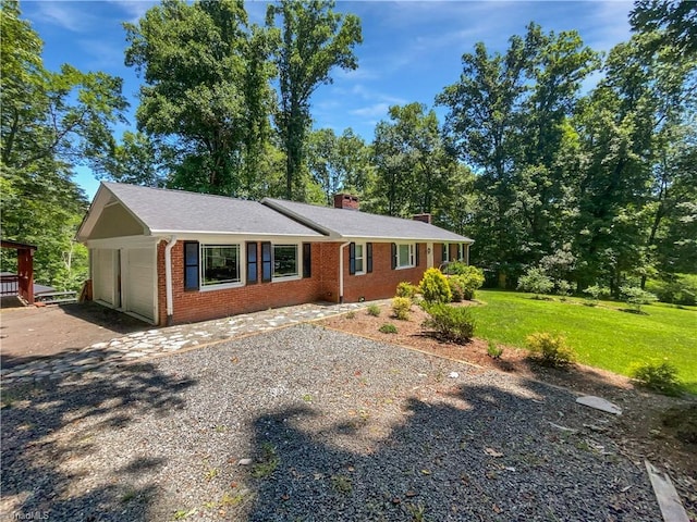 3230 High Cliffs Rd, Pfafftown, NC 27040 - single story home with a chimney, brick siding, driveway, and a front lawn
