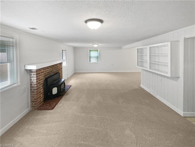3230 High Cliffs Rd, Pfafftown, NC 27040 - unfurnished living room with a wood stove, carpet floors, and a textured ceiling