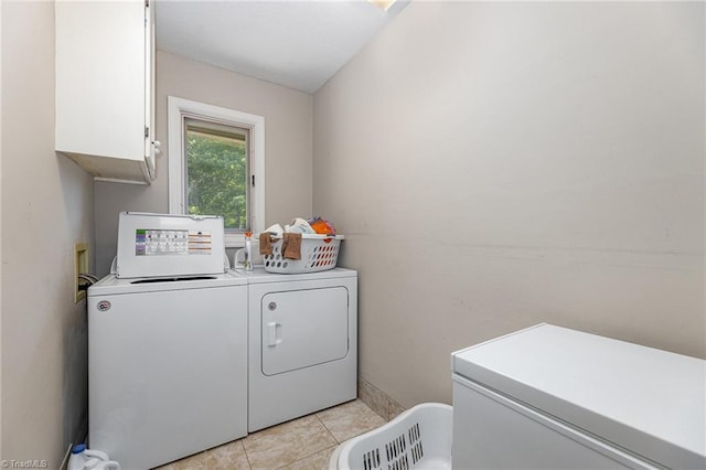 4680 Sherborne Dr, Pfafftown, NC 27040 - laundry room featuring washer and clothes dryer, cabinet space, and light tile patterned floors