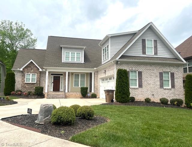 view of front of house with a garage and a front yard